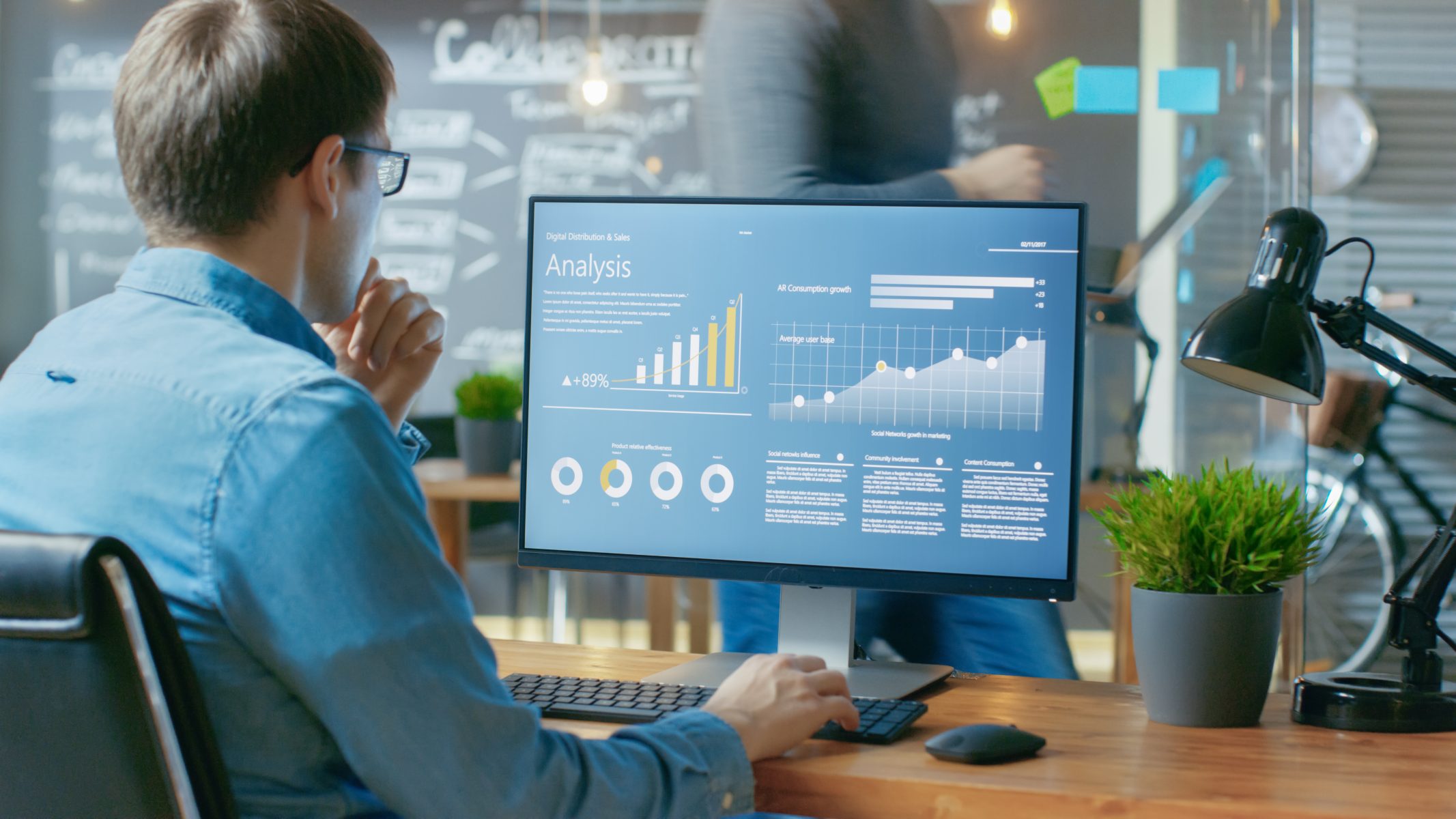 Analyst Works on a Personal Computer Showing Statistics, Graphs and ...